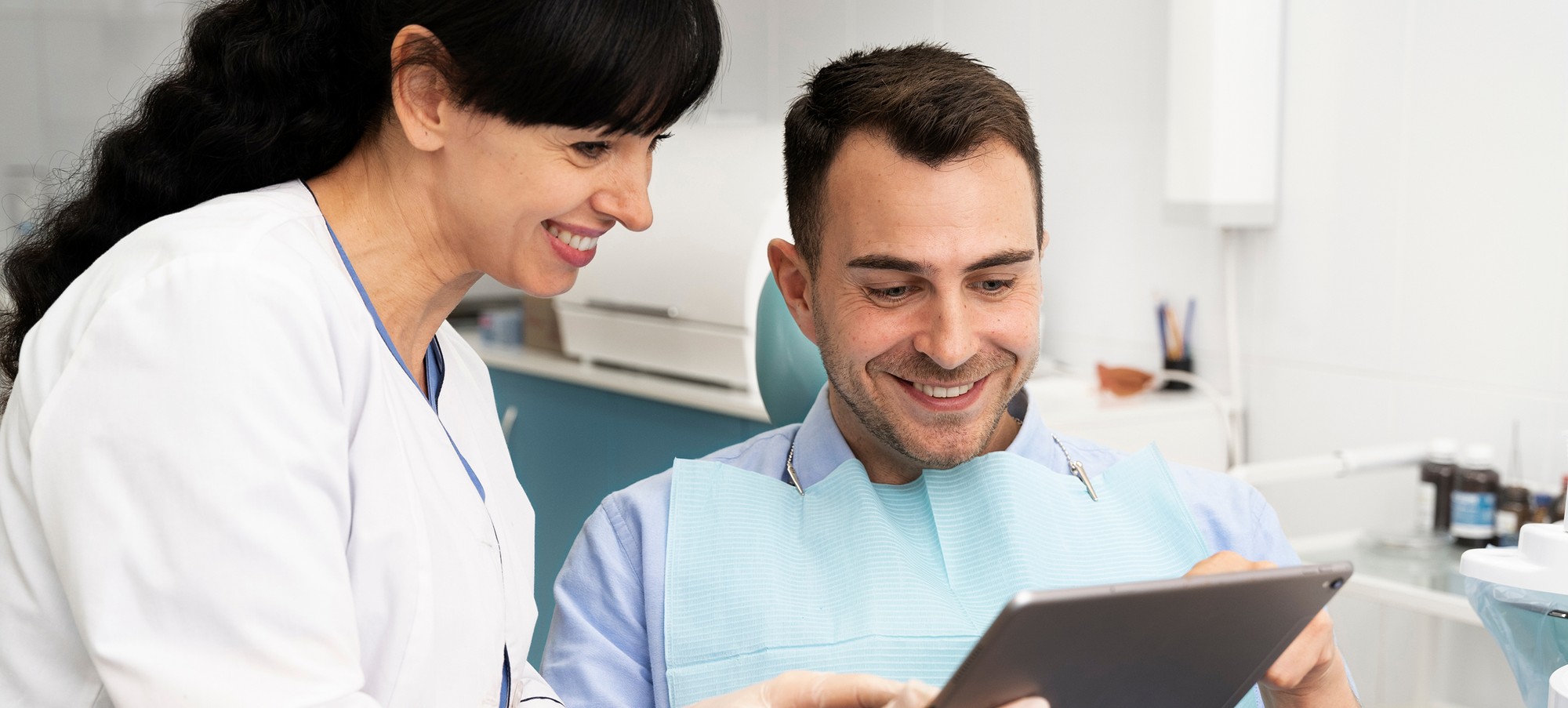 staff talking to patient with clipboard