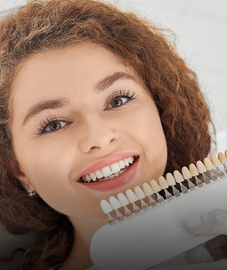 woman with veneers options in a dental office